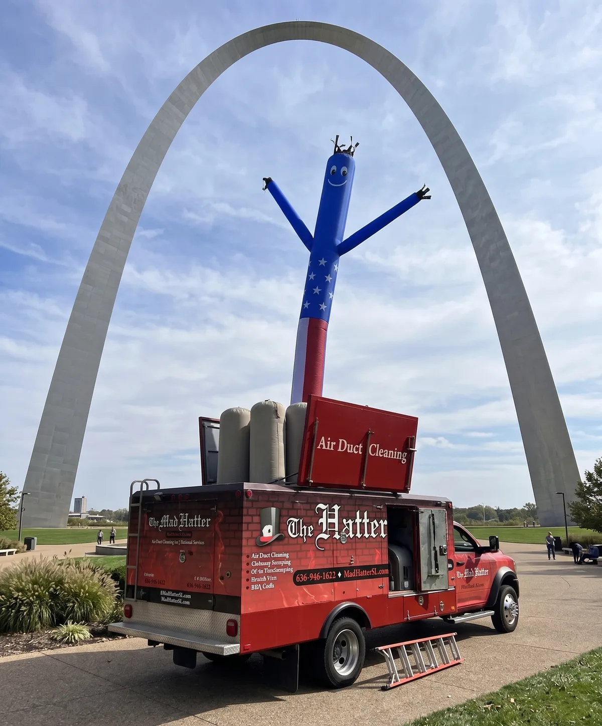 Mad Hatter air duct cleaning truck with its truck-mounted vacuum parked beneath the Gateway Arch