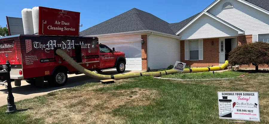 Mad Hatter truck-mounted vacuum connected to a home for air duct cleaning